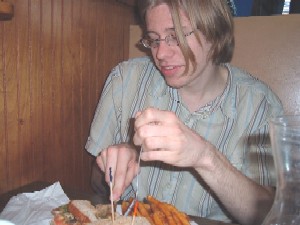 Matt eating a sandwich, called The Reub. Yes, I had to pay for their meals during the photo shoot, although they didn't have much idea of what they were doing.